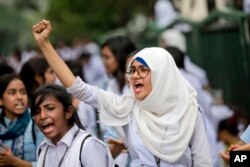 Bangladeshi students shout slogans as they block a road during a protest in Dhaka, Bangladesh, Saturday, Aug. 4, 2018.