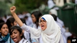 Bangladeshi students shout slogans as they block a road during a protest in Dhaka, Bangladesh, Saturday, Aug. 4, 2018.