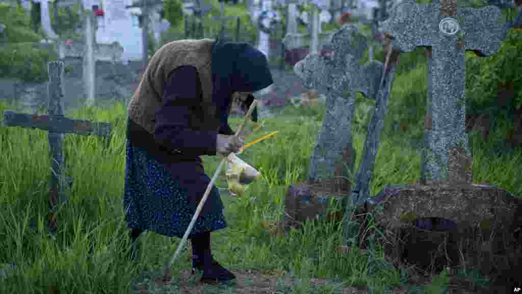 یک زن پیر در جستجوی قبر عزیزانش در رومانیا