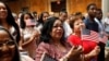 FILE - New citizens stand during a U.S. Citizenship and Immigration Services (USCIS) naturalization ceremony at the New York Public Library in Manhattan, New York, July 3, 2018. 