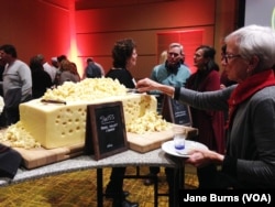 Guests at the U.S. Cheese Championship gala could help themselves to samples from a giant wheel of Swiss cheese that had been among the cheeses judged in the competition, in Green Bay, Wis., March 7, 2019.