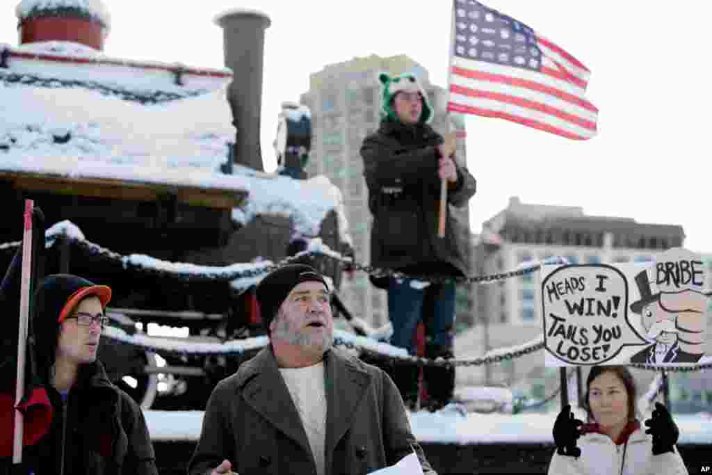 Dec. 12: Brian MacMillan reads a fake resignation letter from Port of Anchorage director Bill Sheffield in front of the Integrated Concepts & Research Corporation (ICRC) office near the Port of Anchorage, Alaska. (AP/Loren Holmes)
