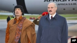 Belarusian President Alexander Lukashenko, right, and Libyan leader Moammar Gadhafi seen during a welcome ceremony in Minsk, Belarus, Saturday, Nov. 2, 2008