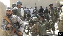 Afghan security forces are seen after Taliban militants opened fire on delegation of senior Afghan officials in Panjwai, Kandahar province in southern Afghanistan, March. 13, 2012. 