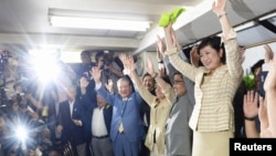 Yuriko Koike (R) and her supporters celebrate her win in the Tokyo Governor election in Tokyo, Japan, in this photo taken by Kyodo, July 31, 2016.
