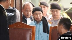 Islamic cleric Aman Abdurrahman arrives at a court ahead of his verdict in Jakarta, Indonesia, June 22, 2018, in this photo taken by Antara Foto. 