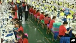FILE - In this file image from undated video footage run by China's CCTV via AP Video, trainees work in a garment factory at the Hotan Vocational Education (CCTV via AP Video, File)
