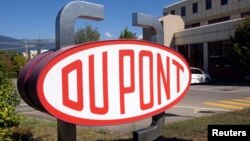FILE - A DuPont logo is pictured on the research center in Meyrin near Geneva.