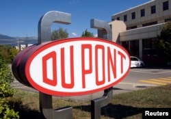 FILE - A DuPont logo is pictured on the research center in Meyrin near Geneva.