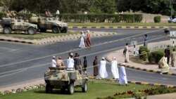 Soldiers keep watch from army armored vehicles at a roundabout after protesters dispersed in the northern industrial town of Sohar in Oman March 1, 2011