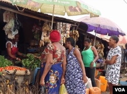 Women are shopping at a market in Abuja, Nigeria, in this screen grab taken from video.