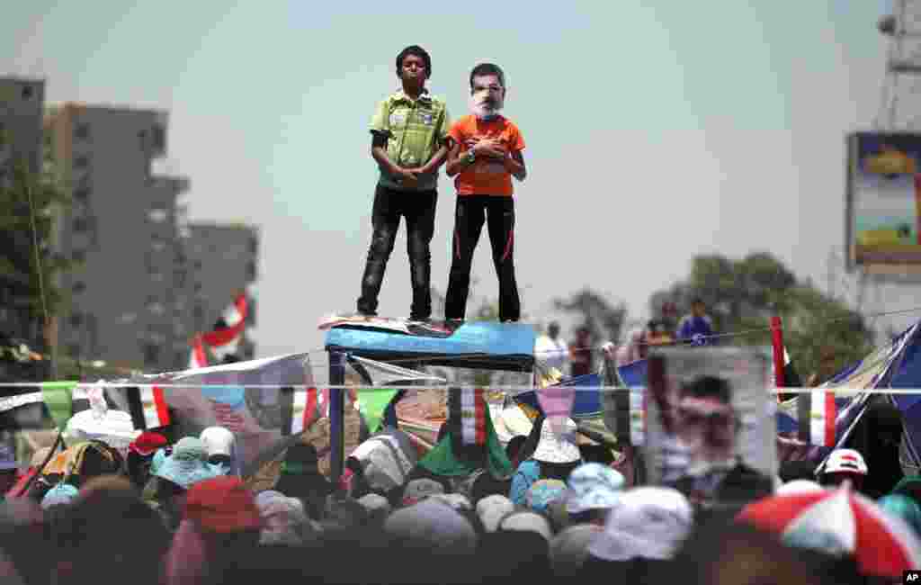 Supporters of ousted President Mohamed Morsi attend Friday prayer at Nasr City, where protesters have installed their camp and hold daily rallies in Cairo, July 26, 2013.