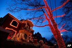 A house and tree are decorated for Christmas in the Brooklyn neighborhood of Dyker Heights, New York, Dec. 14, 2016.