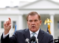 FILE - Former Secretary of Homeland Security Tom Ridge speaks to a crowd of hundreds protesting in front of the White House in Washington.