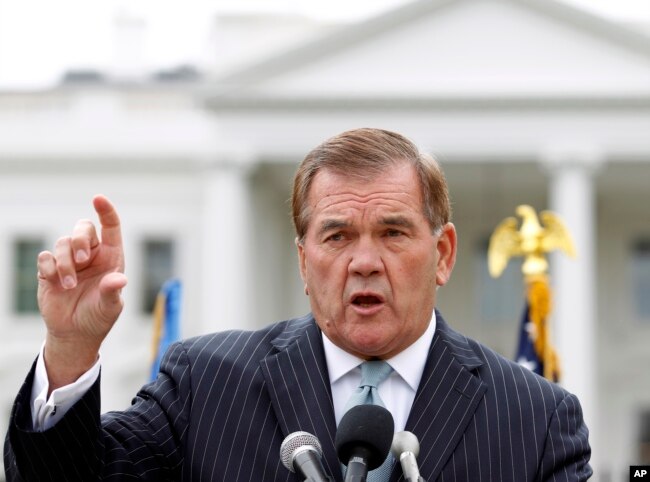 FILE - Former Secretary of Homeland Security Tom Ridge speaks to a crowd of hundreds protesting in front of the White House in Washington.