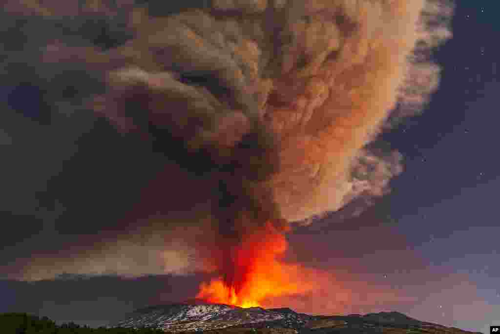 Smoke billows from the Mt. Etna volcano, as seen from Nicolosi, Sicily, southern Italy, Feb. 10, 2022. 