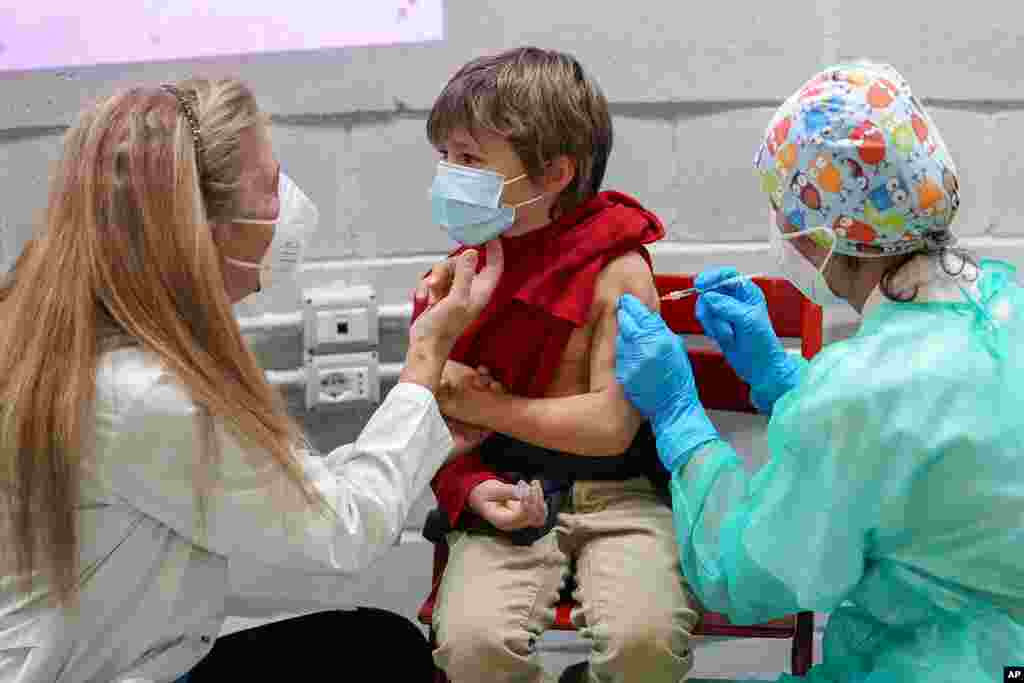 A boy receives a dose of Pfizer-BioNTech COVID-19 vaccination for children aged 5-11, in Rome.