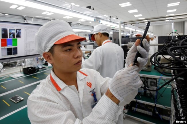 A manufacturer works at an assembly line of Vingroup's Vsmart phone in Hai Phong, Vietnam, Dec. 4, 2018.