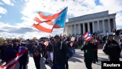Members of the Hispanic Federation participate in the Unity March to highlight the ongoing humanitarian and natural disaster crisis in Puerto Rico, at the Lincoln Memorial in Washington, Nov. 19, 2017.