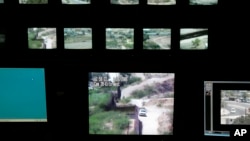 FILE - Screens for surveillance cameras show various points along the border between Nogales, Mexico, and Nogales, Arizona, in a U.S. Border Patrol station in Nogales, Arizona.