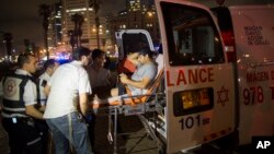 A wounded man is evacuated from the scene of a stabbing attack in Jaffa, a mixed Jewish-Arab part of Tel Aviv, Israel, March 8, 2016. 