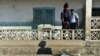 Un policier pend en photo d'une urne détruite au bureau de vote de Hankounou, Comores, le 30 juillet 2018.