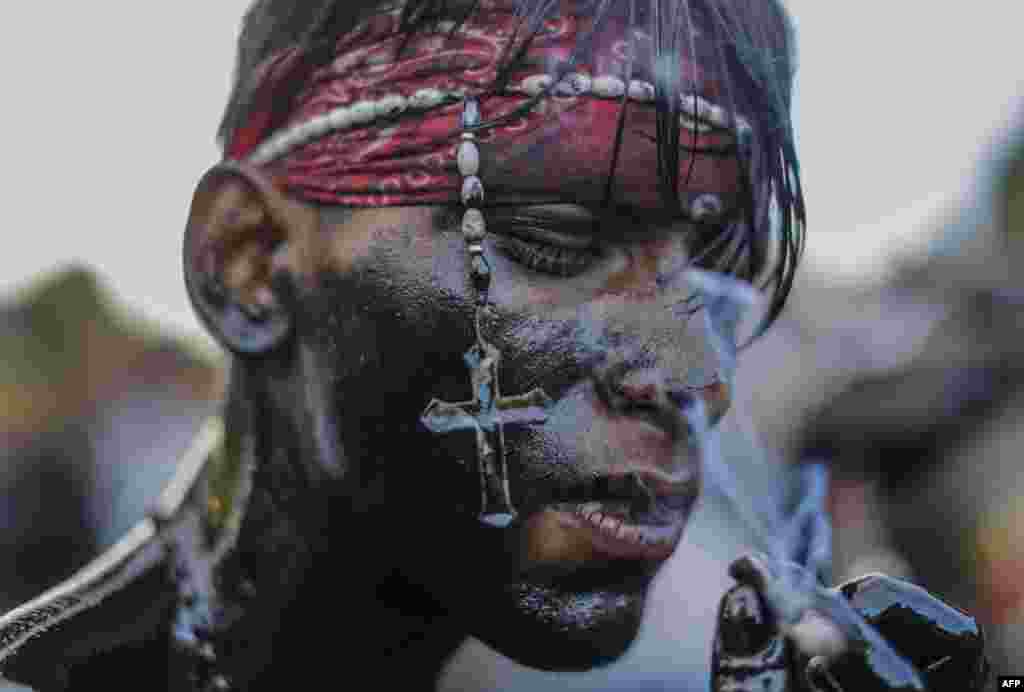 A catholic faithful smeared in burnt oil, takes part in the opening of the ten-day celebration of the Santo Domingo de Guzman festival in Managua, Nicaragua.