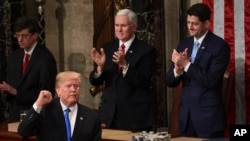 President Donald Trump gestures at the end of his State of the Union address to a joint session of Congress on Capitol Hill in Washington, Tuesday, Jan. 30, 2018.
