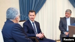 Syria's President Bashar al-Assad (C) meets Alaeddin Boroujerdi (L), head of the Iranian parliamentary committee for national security and foreign policy, in Damascus September 1, 2013.