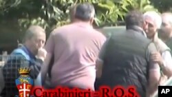 FILE - In this photo taken from video and provided by the Italian Carabinieri (paramilitary police), shows alleged members of Italian crime syndicate 'Ndrangheta.'