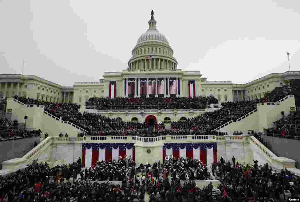 U.S. Supreme Court Chief Justice John Roberts (R, front) administers the oath of office to U.S. President Barack Obama (L, front) during ceremonies on the West front of the U.S. Capitol in Washington, January 21, 2013
