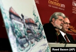 Former University of Southern California student and film director George Lucas, left, and USC president Steven Sample talk with reporters before the ceremonial groundbreaking for a new building at the USC School of Cinematic Arts.