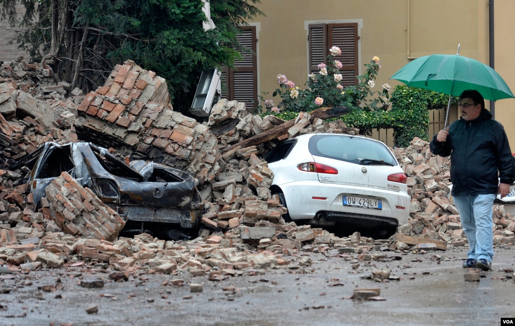 A man looks at the damage caused by a quake in Finale Emilia northern Italy, May 20. 2012. (AP Photo/Marco Vasini)