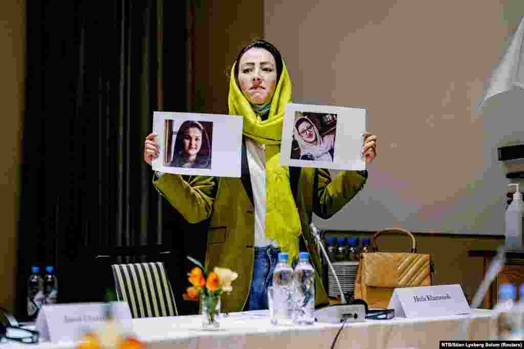 Afghanistan Civil Society Representative Heda Khamoush holds up photos of women&#39;s rights activists recently detained in Afghanistan, during a meeting with Afghan Taliban members at the Soria Moria hotel in Oslo, Norway.