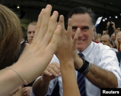 Republican presidential nominee Mitt Romney greets audience members at a campaign rally at the airport in Sanford, Florida, November 5, 2012.