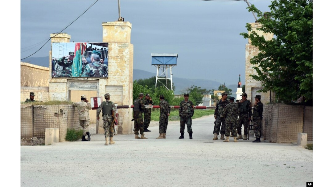 Afghan soldiers stand guard at the gate of a military base in Mazar-i-Sharif, Afghanistan, April 21, 2017, after an attack by Taliban suicide bombers and gunmen who entered the compound wearing Afghan army uniforms.