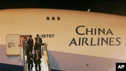 Taiwanese pilots and crews are escorted by Chinese officials from a Taiwanese carrier at Pudong international airport in Shanghai, China (FILE).