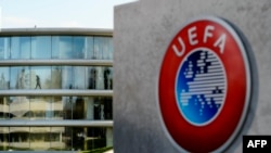 A man walks inside the headquarters of European football body UEFA in Nyon on April 6, 2016. Swiss police raided the UEFA headquarters on April 6 following the latest revelations of a web of Panama-based offshore financial dealings by the rich and famous.
