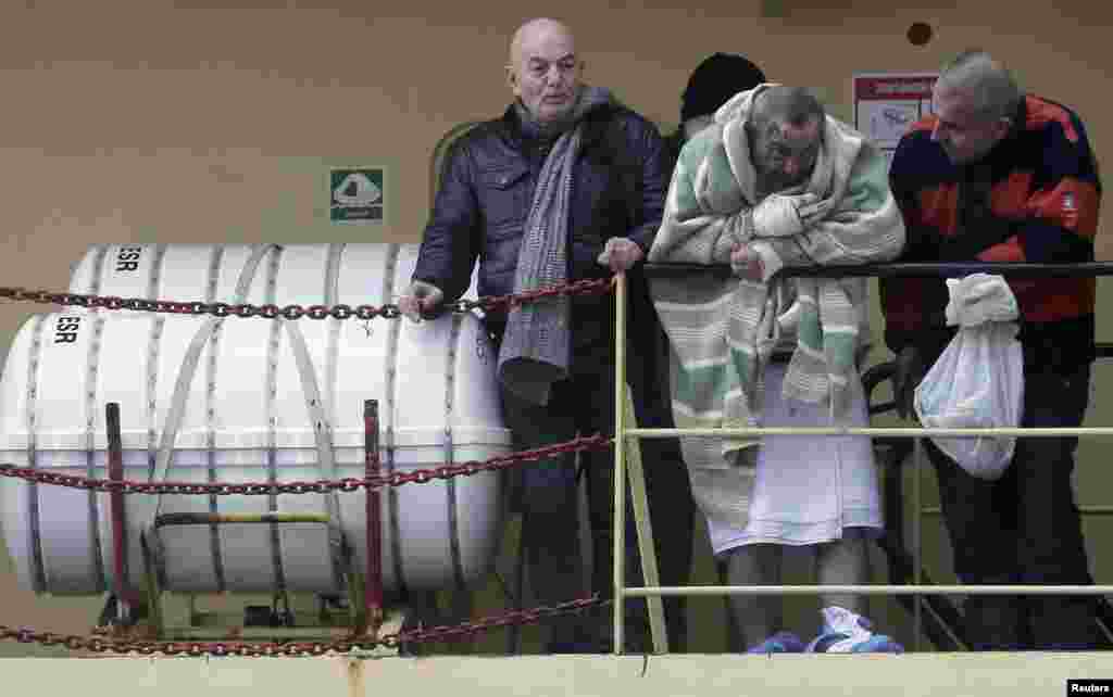 A wounded passenger waits to leave from the " Spirit of Piraeus " cargo container ship at Bari Harbor, after the car ferry Norman Atlantic caught fire in waters off Greece, Dec. 29, 2014.