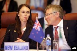 New Zealand Trade Minister David Parker talks with his country's prime minister, Jacinda Ardern, at a Trans-Pacific Partnership meeting in Danang, Vietnam, Nov. 10, 2017.