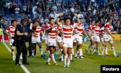 Japan celebrate victory after IRB Rugby World Cup 2015 Pool B match, Sept. 19, 2015.