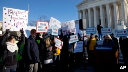 People participate in a rally at the Supreme Court in Washington, Jan. 11, 2016, as the court heard arguments in the 'Friedrichs v. California Teachers Association' case. 