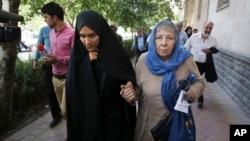 FILE - Mary Rezaian, mother of detained Washington Post correspondent Jason Rezaian, right, and Jason's wife Yeganeh leave a Revolutionary Court building in Tehran, Iran, Aug. 10, 2015. 