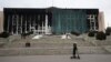 Municipal workers cover the burnt city hall building for repairs in Almaty, Kazakhstan, Jan. 13, 2022, following anti-government protests earlier this month that have since been quelled.