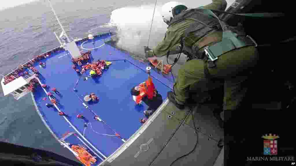 In this image taken from video and released by the Italian Navy, a woman is lifted from the deck of the Italian-flagged ferry Norman Atlantic by a rescue helicopter after it caught fire in the Adriatic Sea, Dec. 28, 2014.