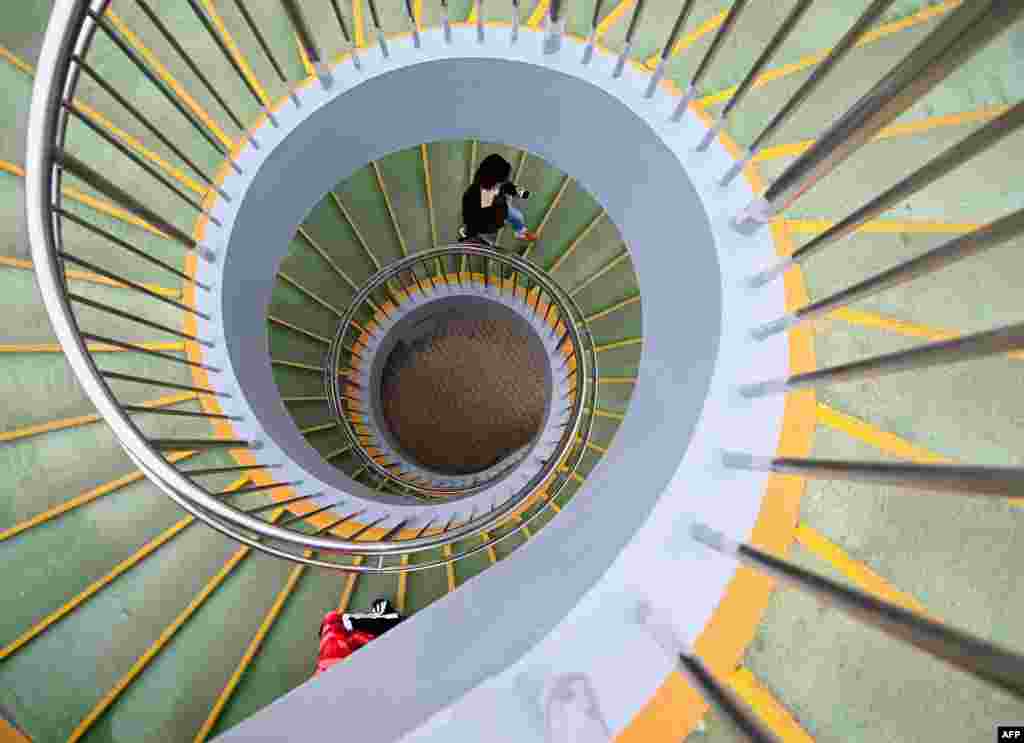 A pedestrian walks up a staircase of an overpass in Beijing.