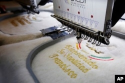 An embroidery machine gives the last touches to a ruana, a traditional Colombian garment, that will be given to Pope Francis during his upcoming visit to Colombia, in Nobsa, Colombia, Aug. 25, 2017.