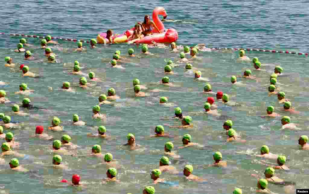 People participate in the annual public Lake Zurich crossing swimming event in Zurich, Switzerland.