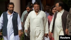 Pakistan's former president and head of the All Pakistan Muslim League political party, Pervez Musharraf (C), arrives with party leaders to unveil his party manifesto for the forthcoming general election, at his residence in Islamabad, April 15, 2013.