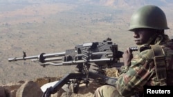 A Cameroonian soldier guards at an observation post on a hill in the Mandara Mountain chain in Mabass overlooking Nigeria, northern Cameroon, February 16, 2015. Boko Haram militants kidnapped some 80 people from the village on January 18, according to the